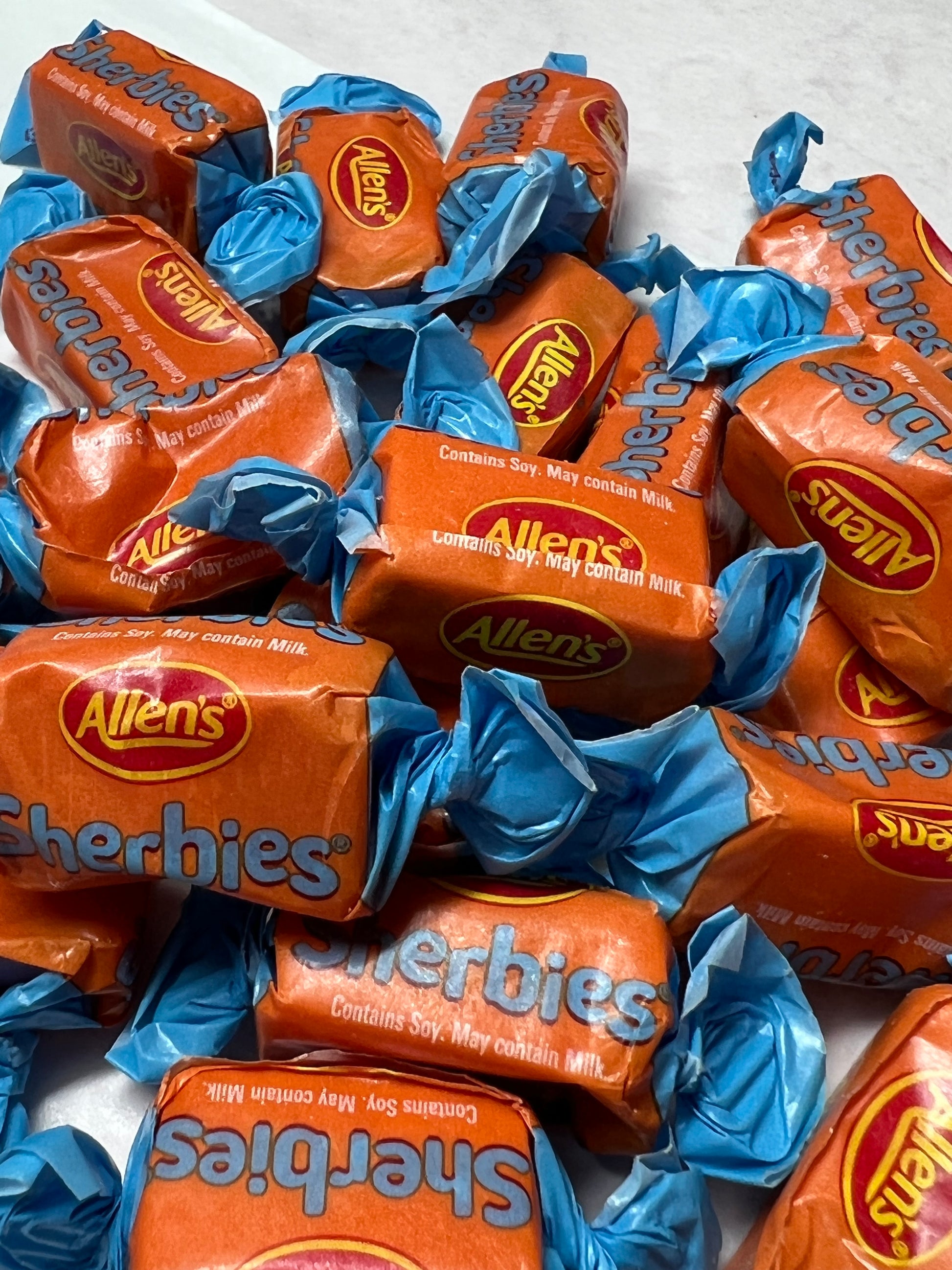 Allens Sherbies candy wrapped in colorful orange and blue packaging for a delightful treat