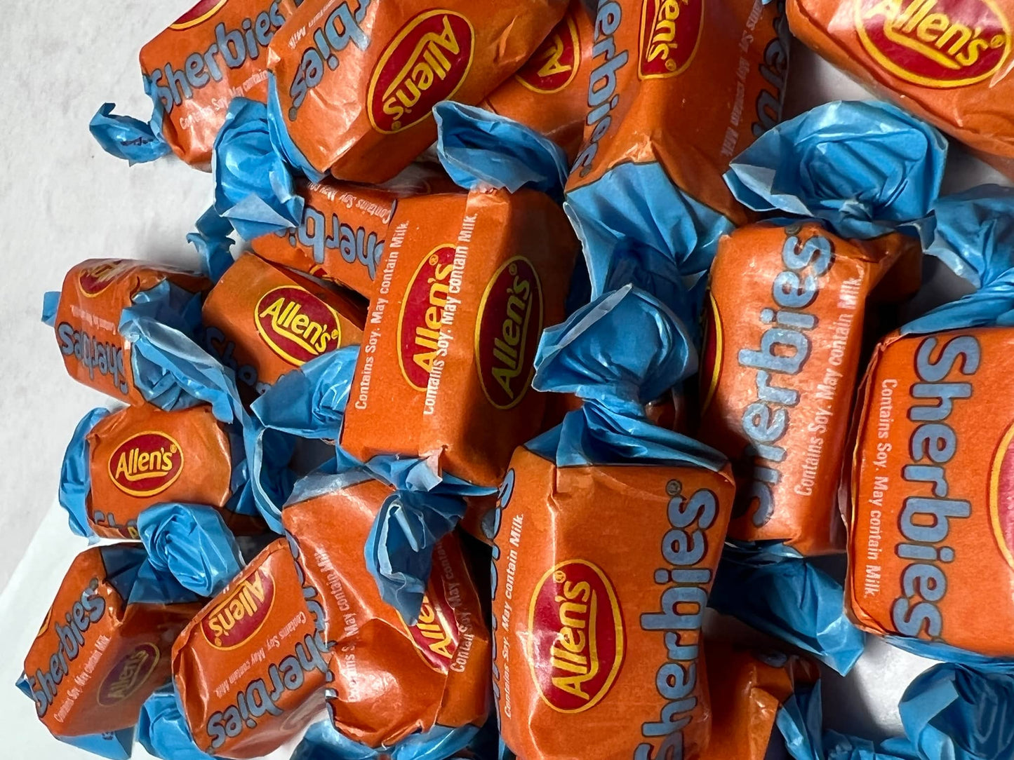 Allens Sherbies candy wrapped in colorful orange and blue packaging for a delightful treat