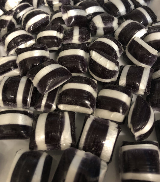 Close-up of black and white striped aniseed humbugs candy pieces from SelectSweets