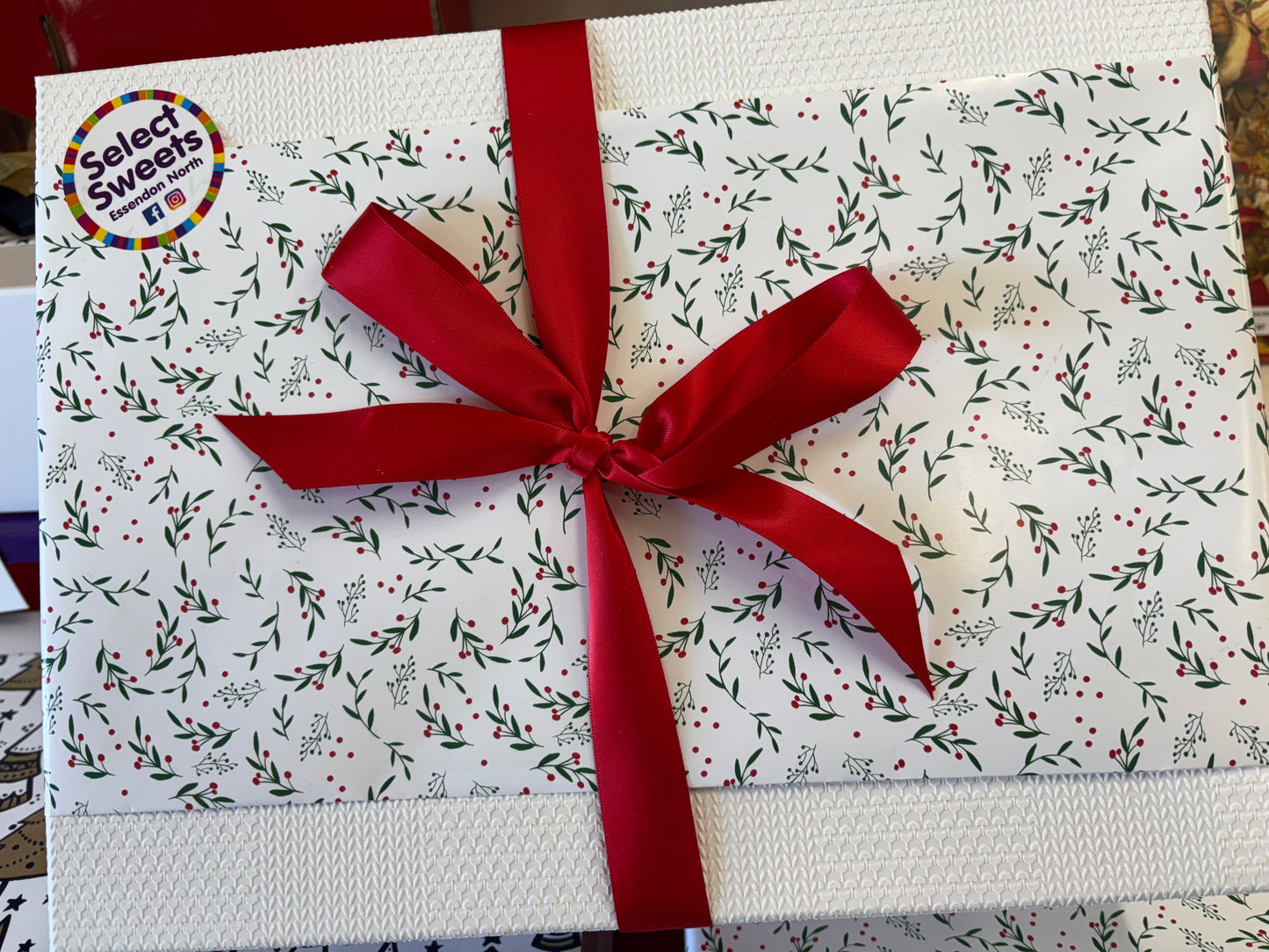 Select Sweets Christmas hamper gift basket beautifully wrapped with festive bow and floral design