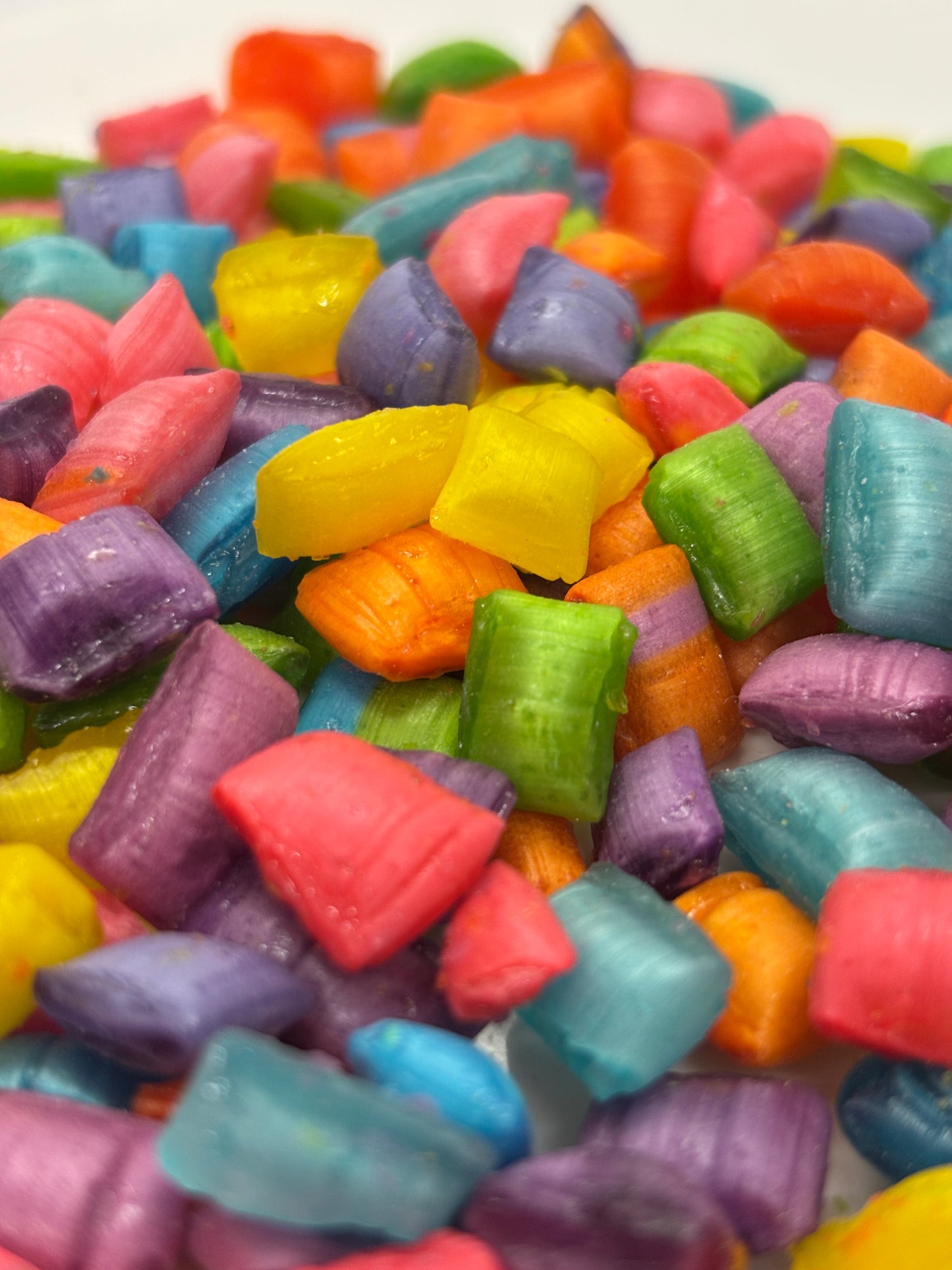 Select Sweets colorful hard candies in bright yellow green purple blue red and orange close-up