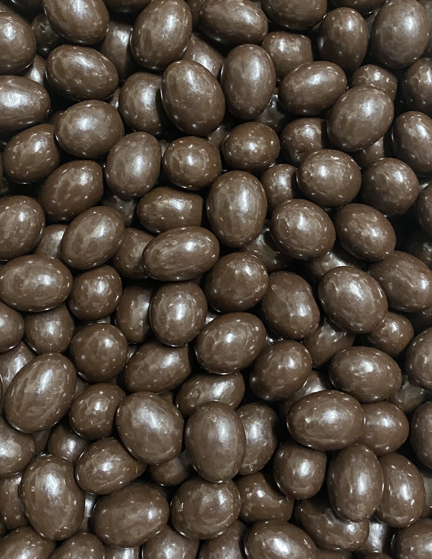 SelectSweets dark chocolate almonds with smooth glossy coating in close-up view