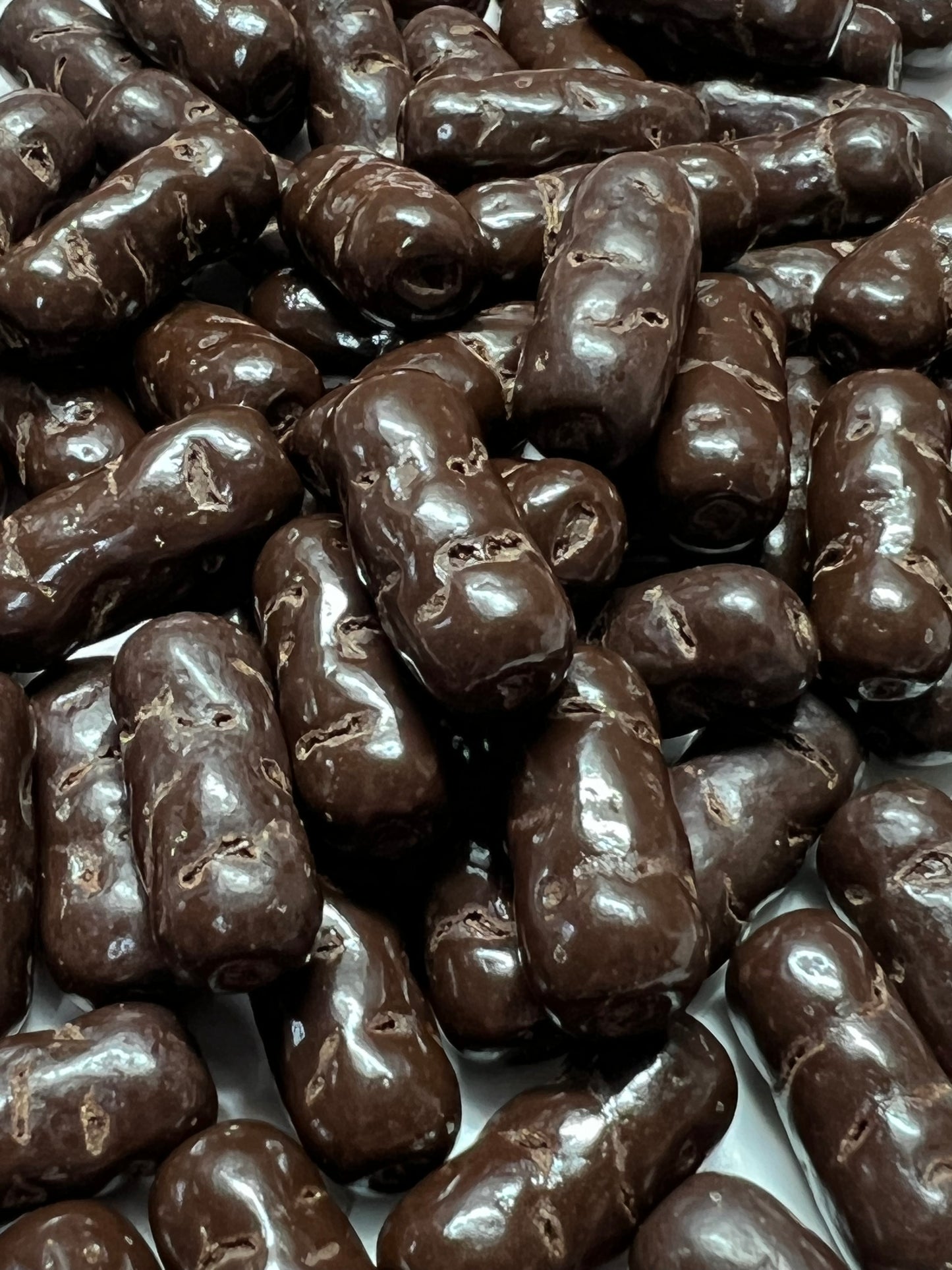 SelectSweets dark chocolate licorice bullets with glossy coating close-up view