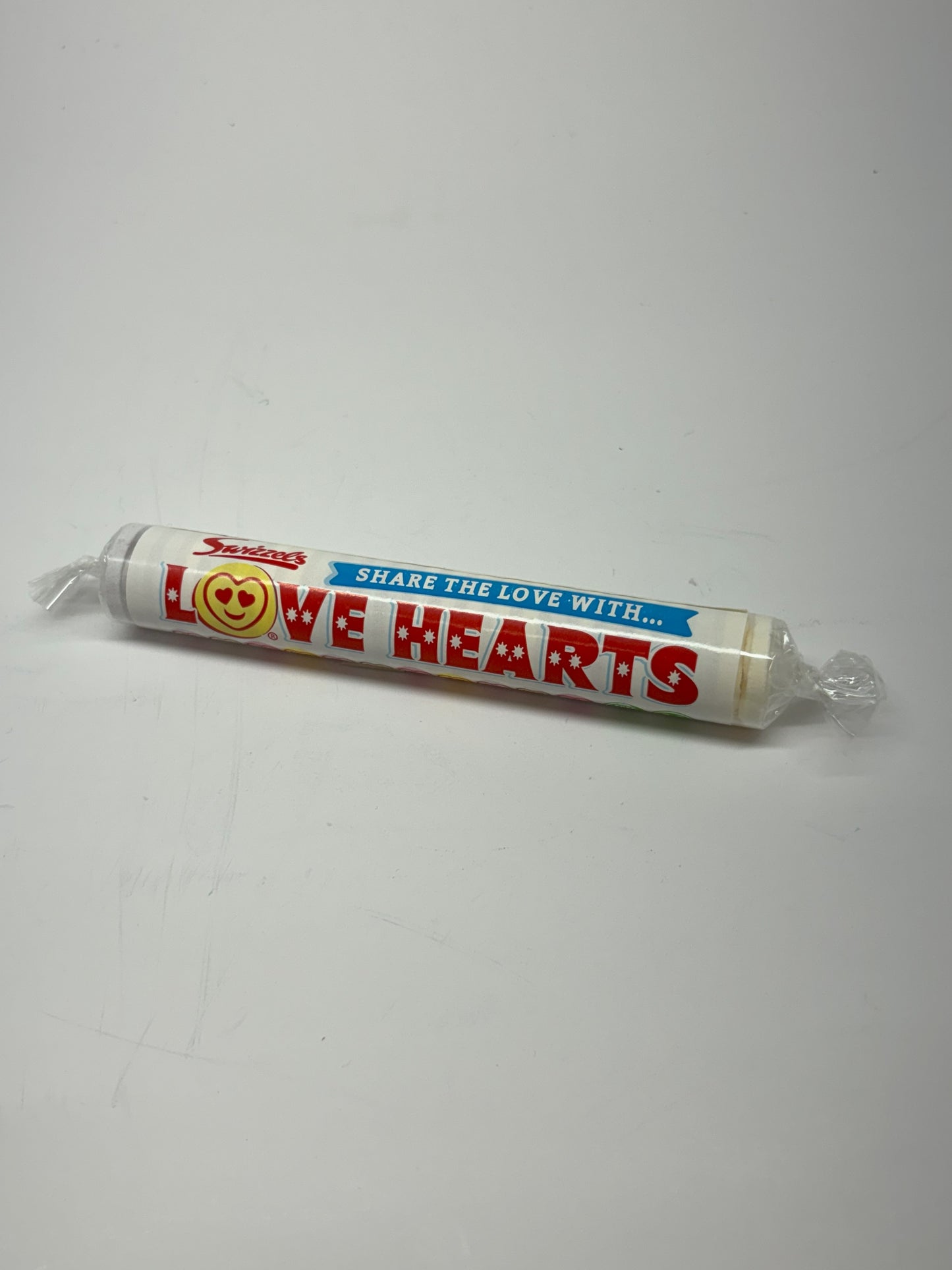 Select Sweets giant fizzers candy Love Hearts tube with red and blue packaging on white background