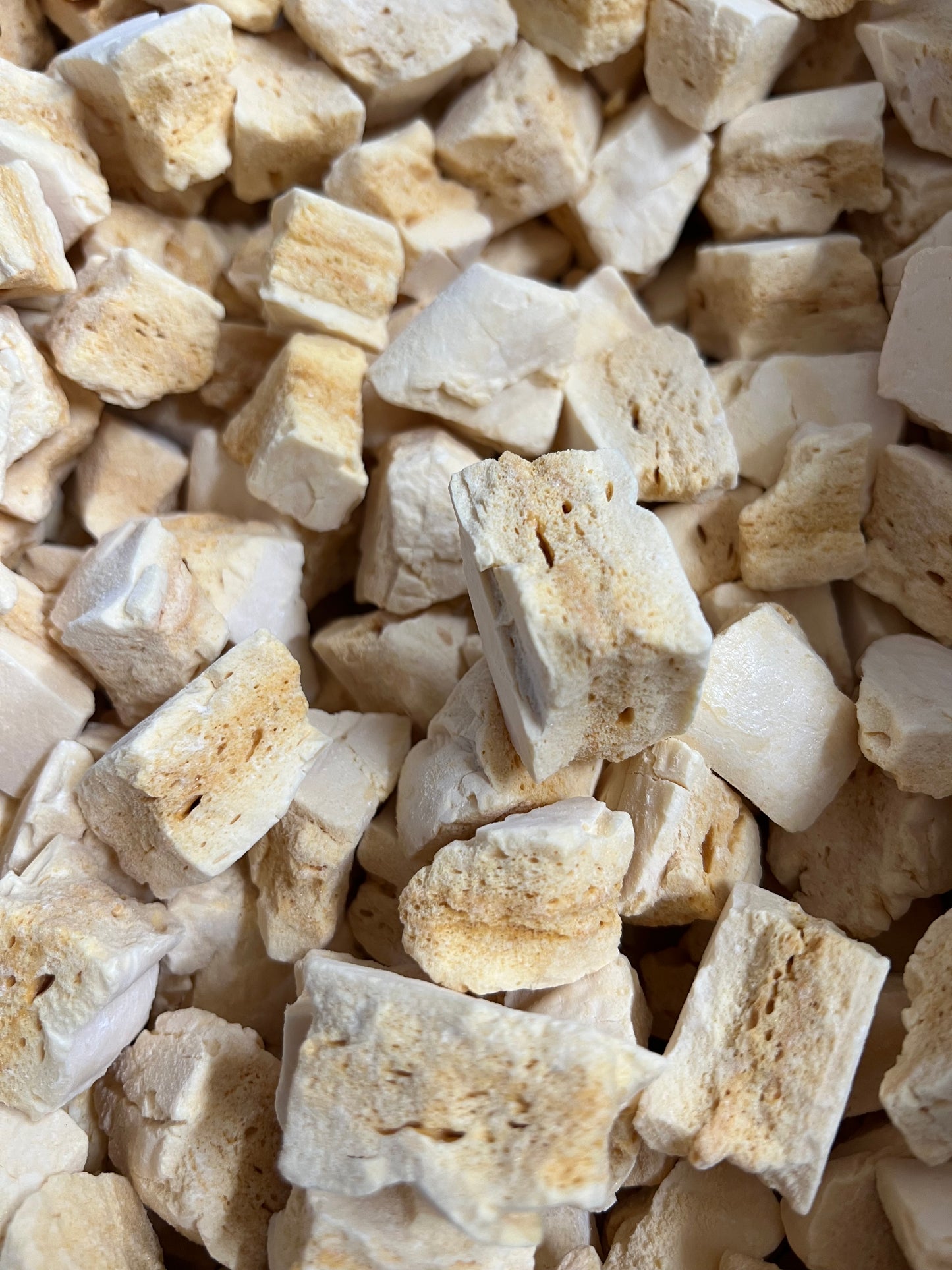 Close-up of Select Sweets honeycomb candy pieces with light golden and white textures
