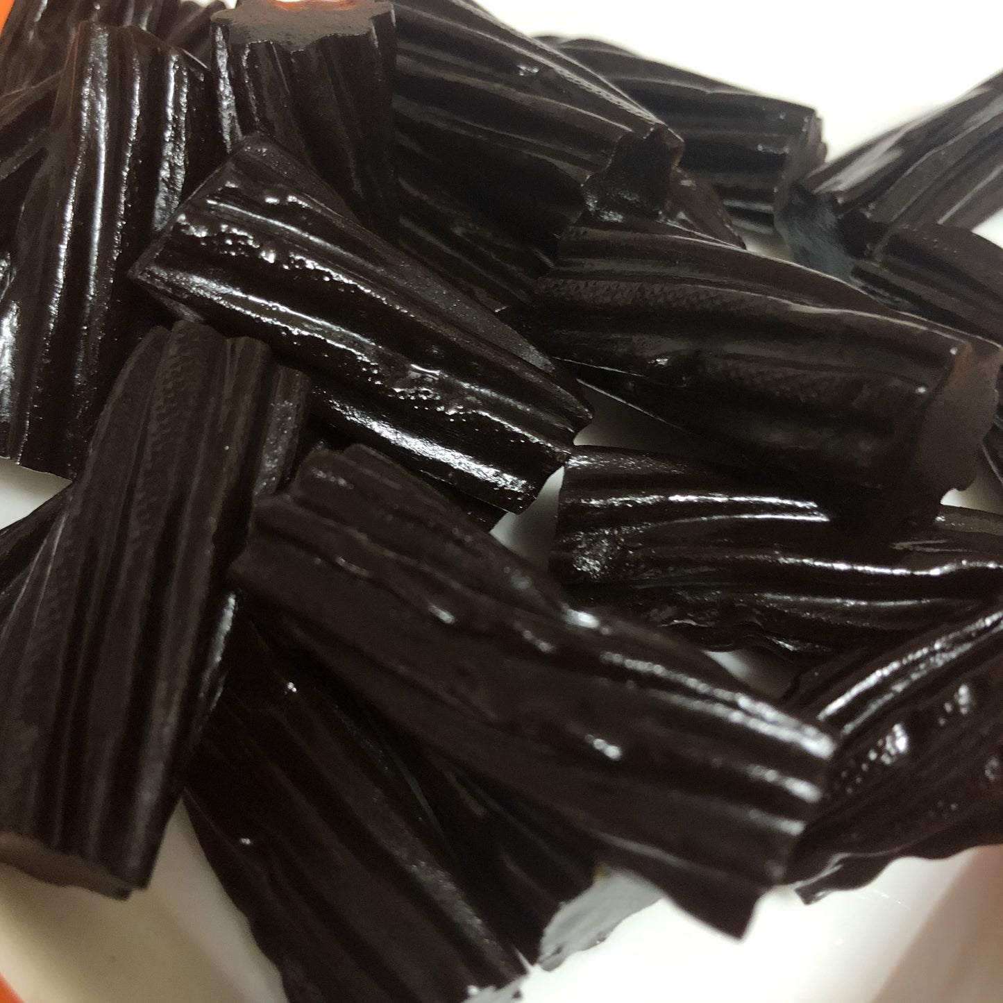 Select Sweets Licorice Twists in a bowl, showcasing their rich black color and chewy texture
