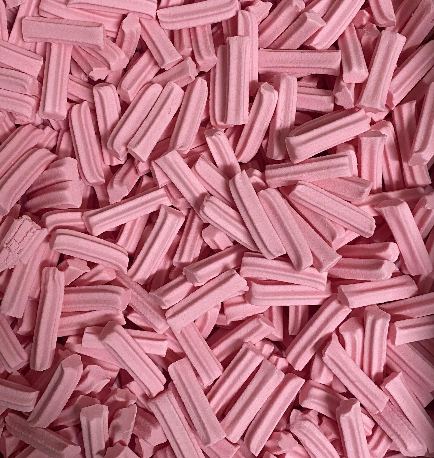 Close-up of pink Select Sweets mini musk sticks candy showing texture and color