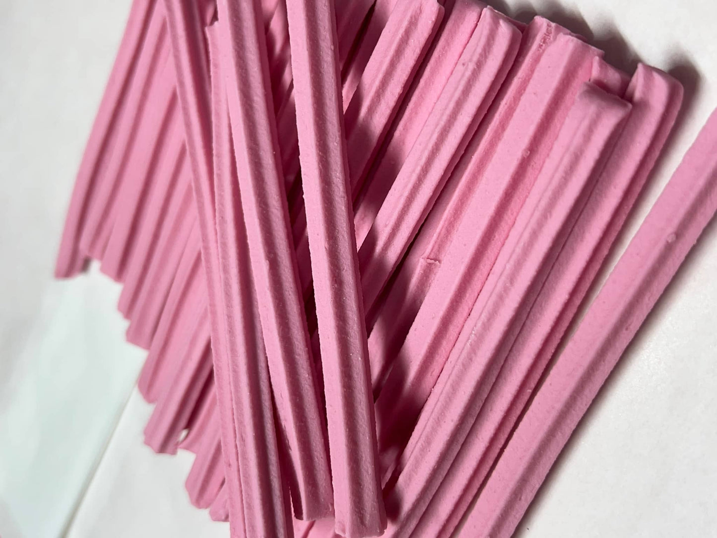 Musk sticks candy in a pile with a soft pink texture, perfect for sweet snacking