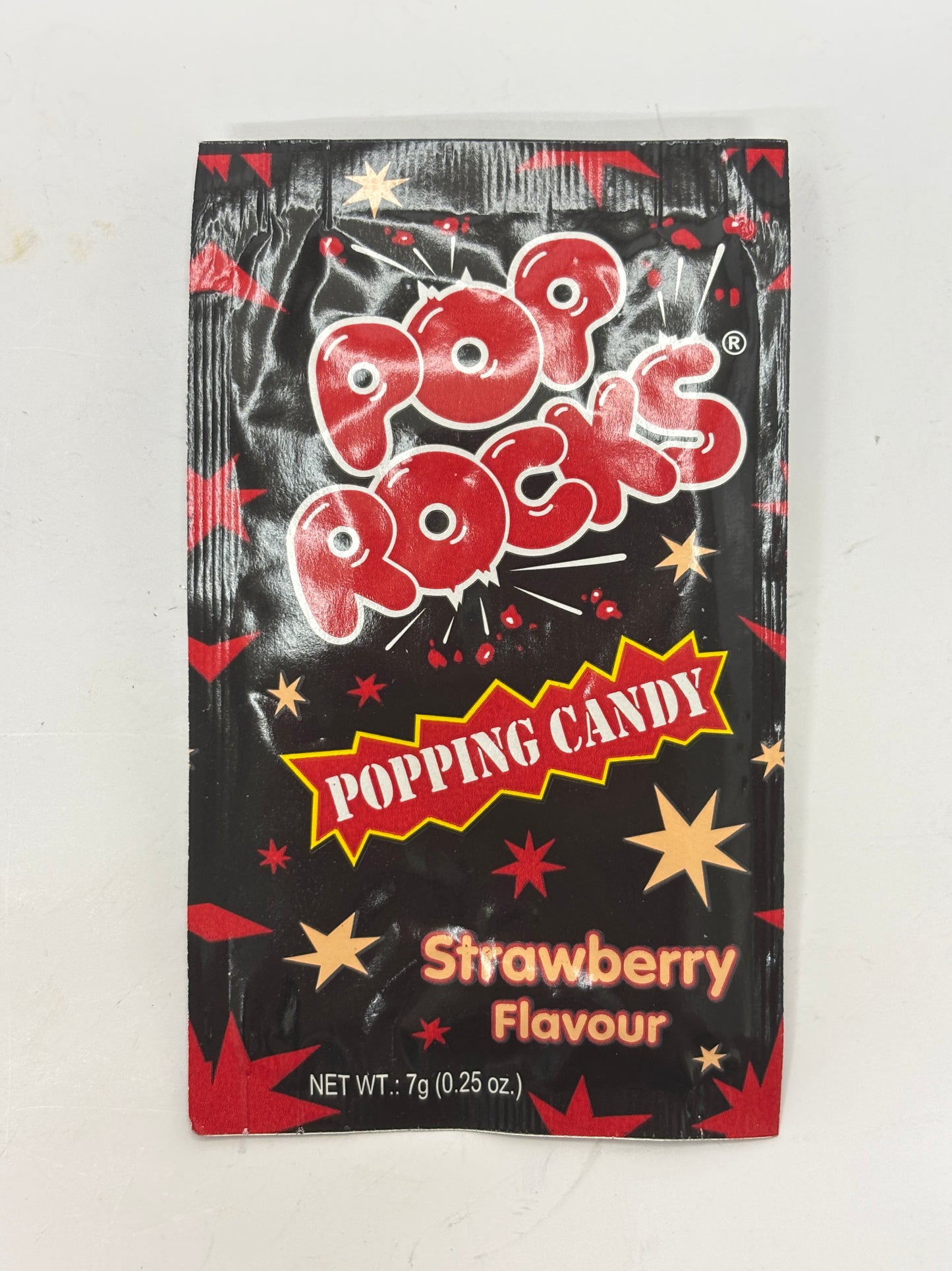 Pop Rocks Strawberry candy popping candy packet with red and black star design and 7g net weight