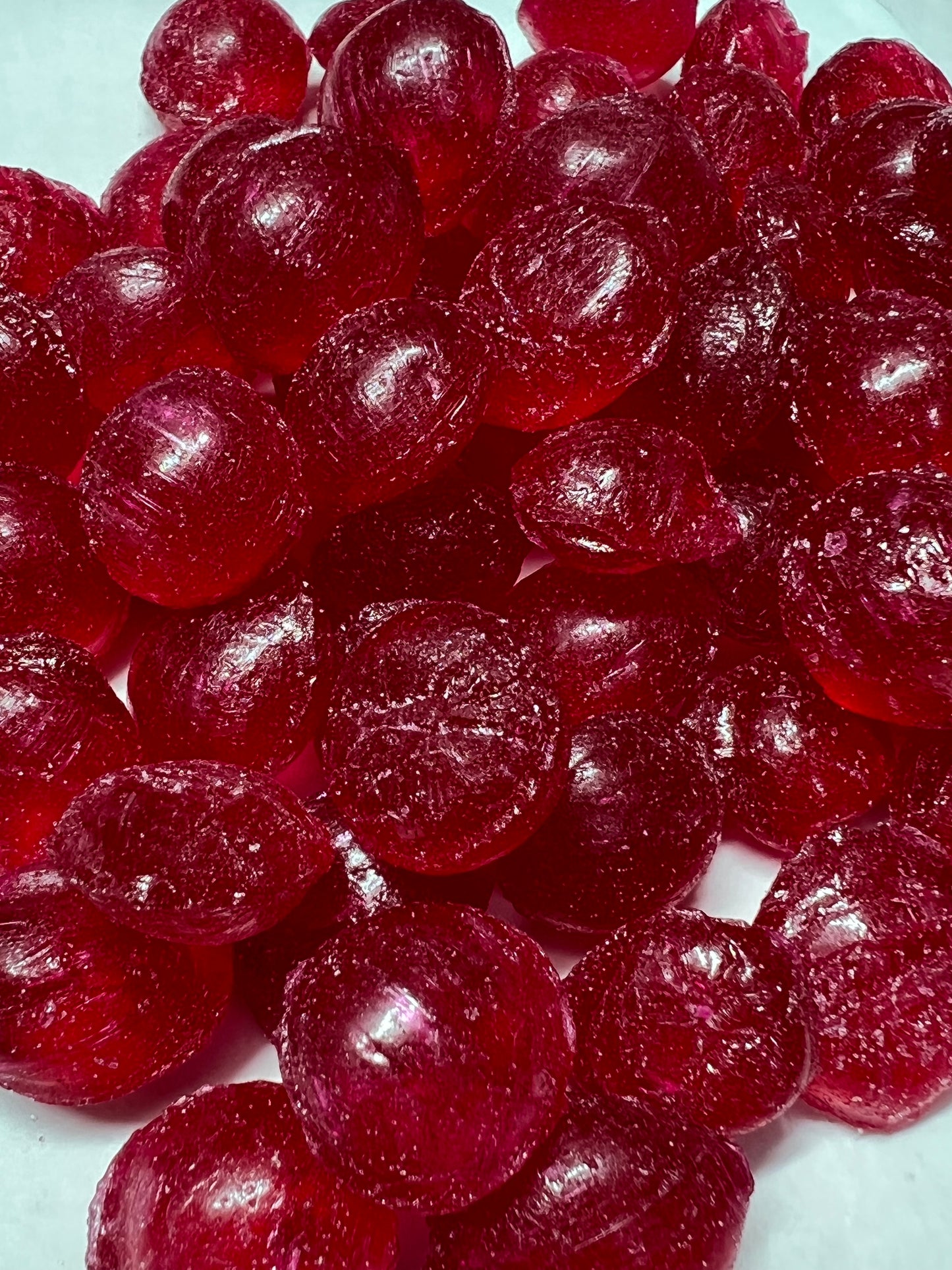 SelectSweets raspberry hard candy in dark red color with glossy texture close-up view