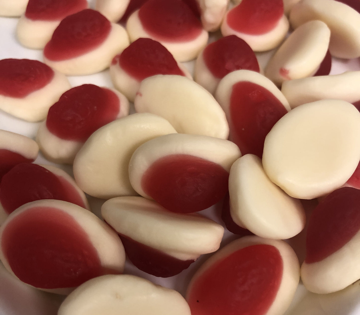Select Sweets strawberries and cream candy with red and white soft gummy texture close-up