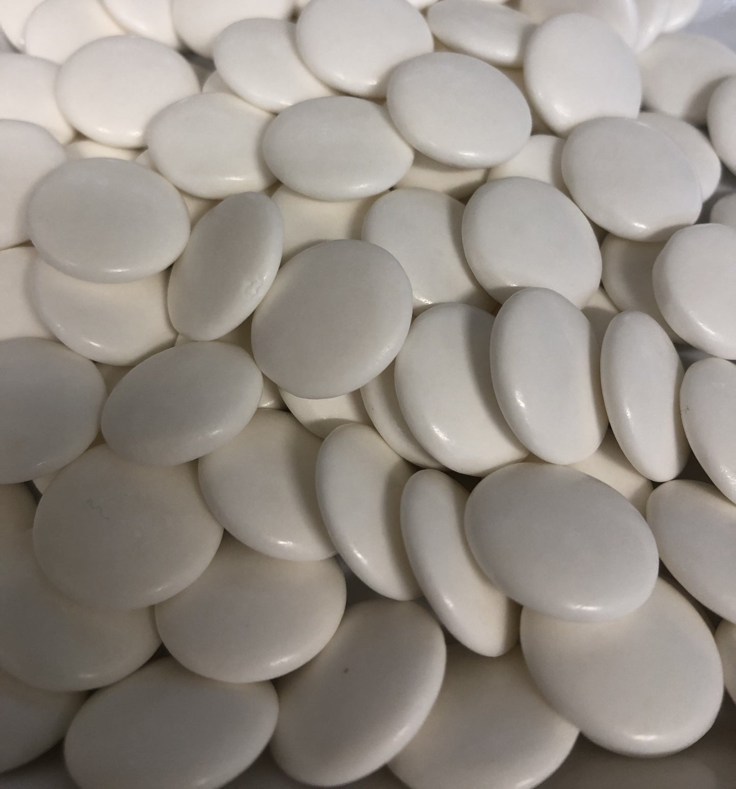 Close-up of SelectSweets1 strong peppermint candies in smooth white round shapes