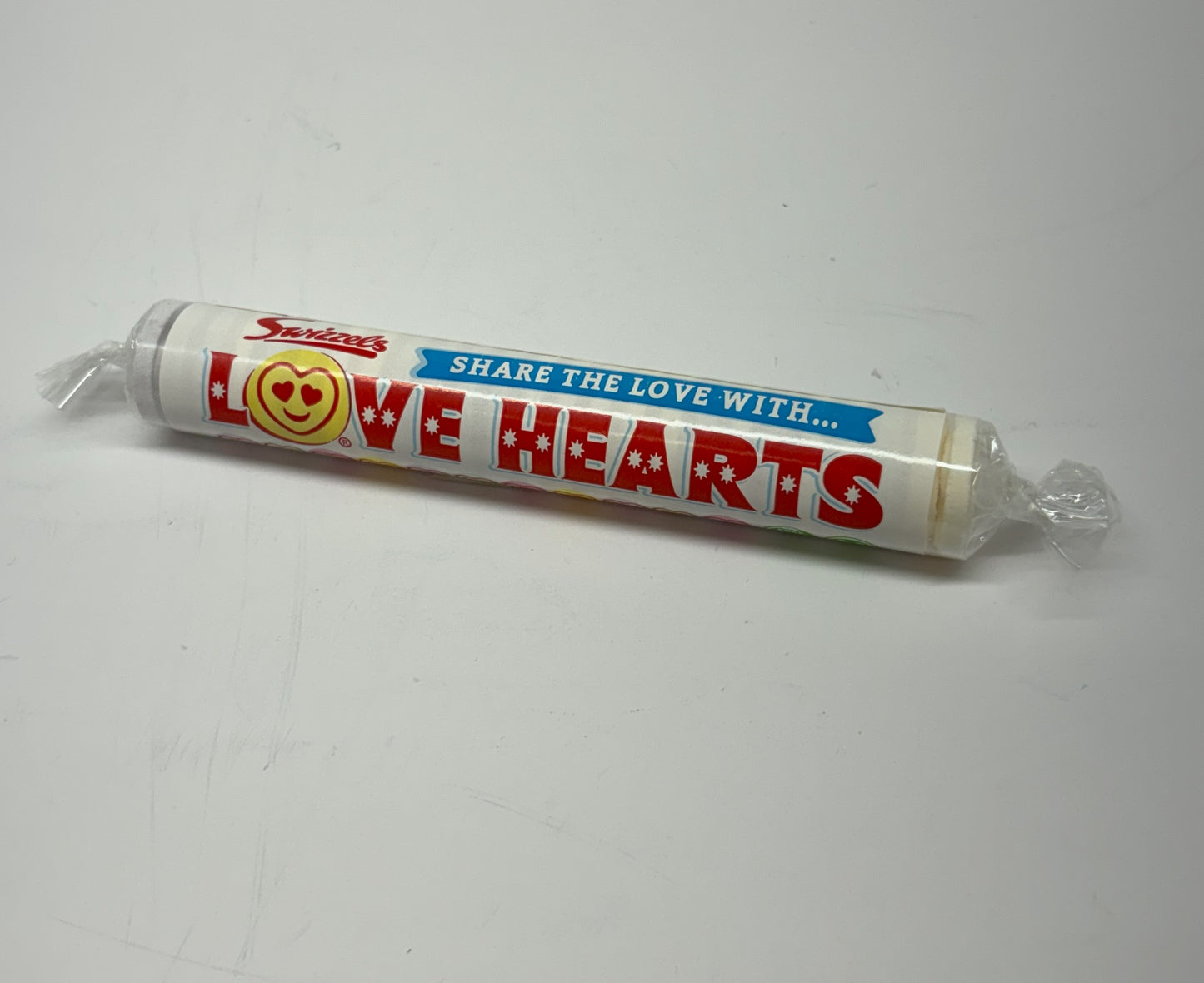 Swizzels Love Hearts candy tube featuring colorful sweet messages for sharing love