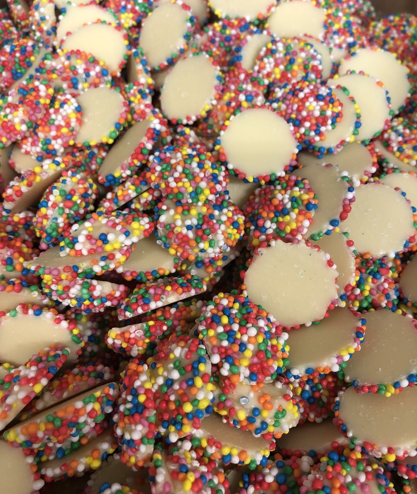 SelectSweets White Chocolate Freckles coated with colorful candy sprinkles in a close-up view