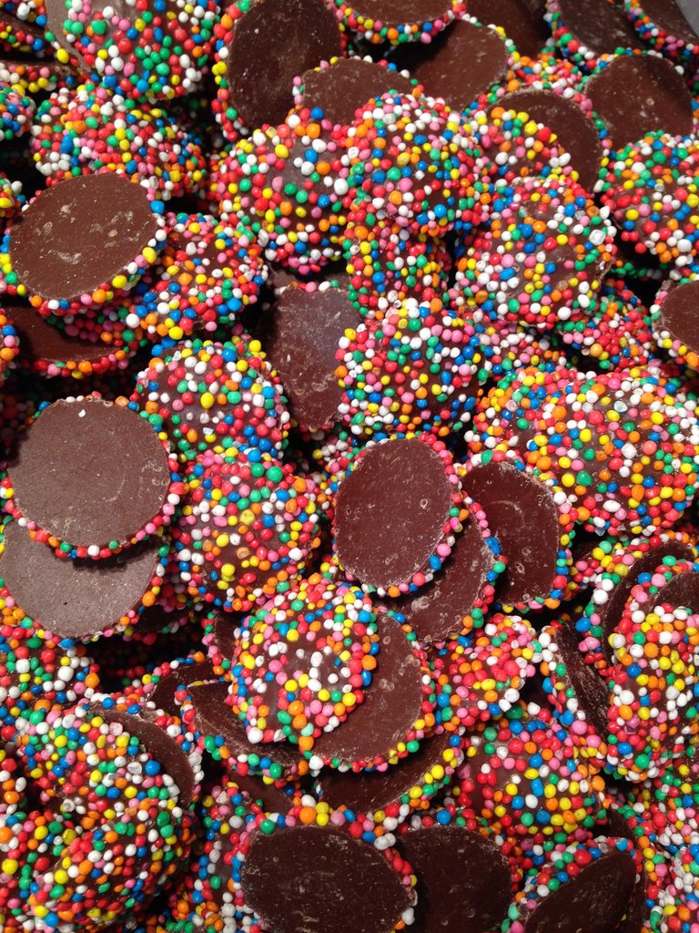 Close-up of SelectSweets milk chocolate freckles covered with colorful candy sprinkles