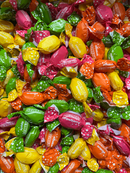 Colorful assortment of assorted candy in fruity flavors like strawberry, orange, and lemon