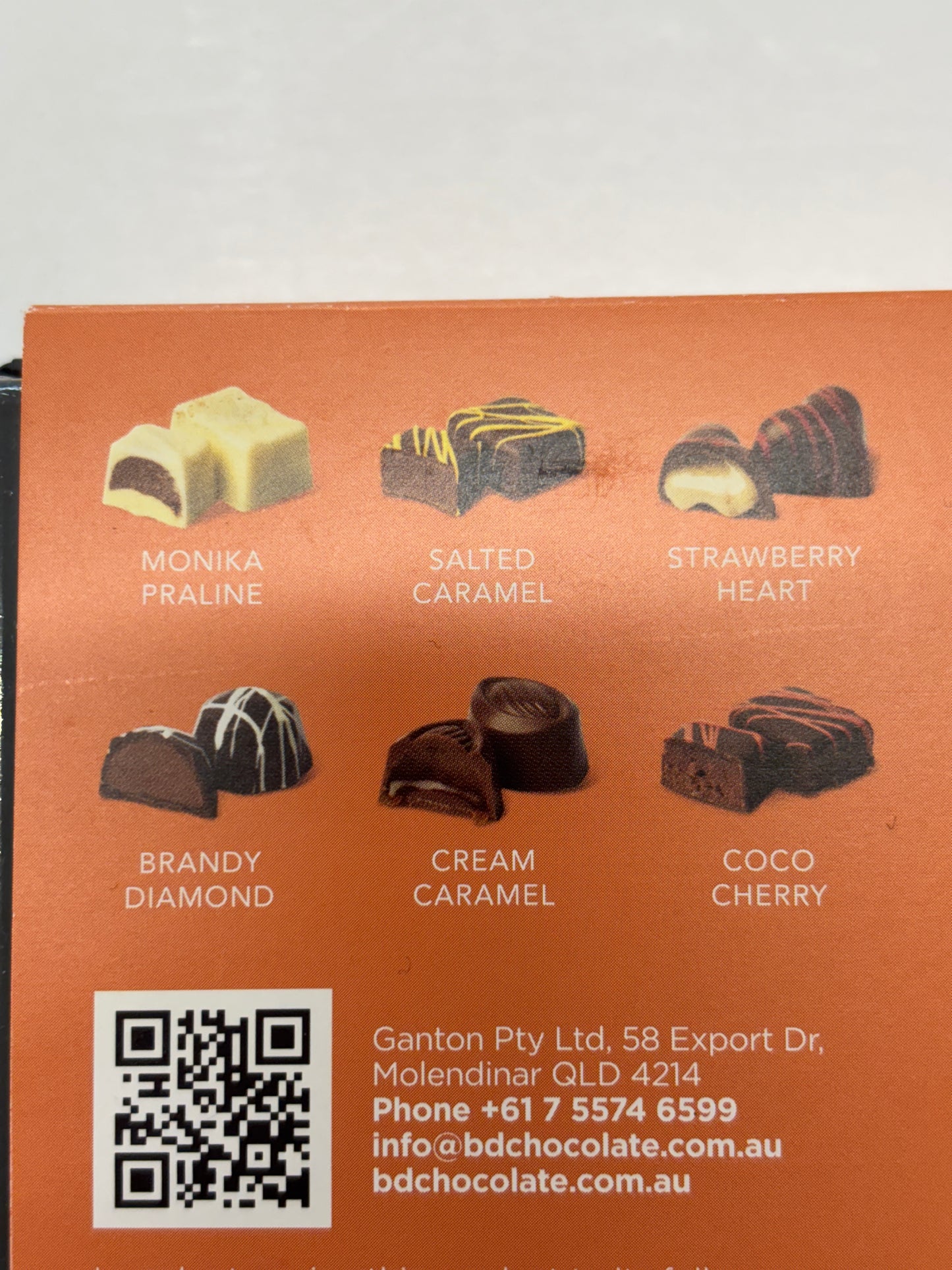Select Sweets packaging showing assorted Belgian dark chocolate pralines with flavor images and QR code