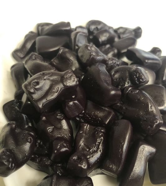 Close-up of SelectSweets black cat licorice candy shaped like small cats and sticks