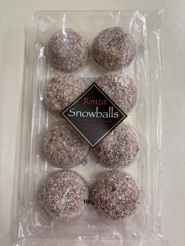 Select Sweets coconut marshmallow snowballs in clear plastic packaging with eight round treats