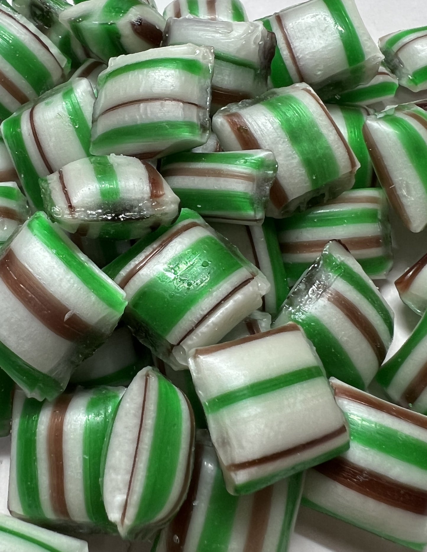 Close-up of SelectSweets chocolate mint candy with green, white, and brown stripes