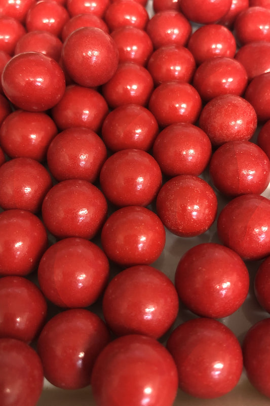 SelectSweets glossy red chocolate orange balls close-up showing smooth candy coating