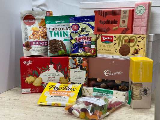 Assorted snacks and treats in a festive Christmas hamper gift basket from Select Sweets