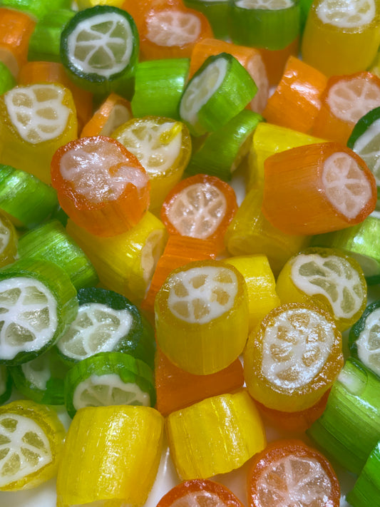 Colorful Citrus Candy Jellies in Green, Yellow, and Orange Shaped Like Citrus Fruits