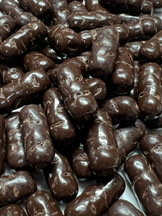SelectSweets dark chocolate licorice bullets with glossy coating close-up view