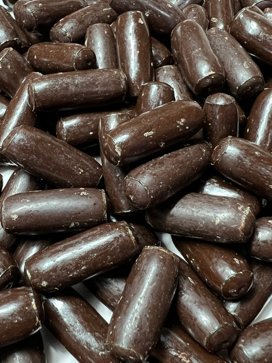 Close-up of SelectSweets dark chocolate licorice bullets with smooth glossy coating