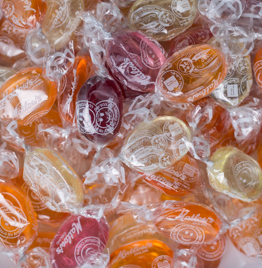 Assorted English crystal fruit candies wrapped in clear cellophane showcasing various fruit flavors