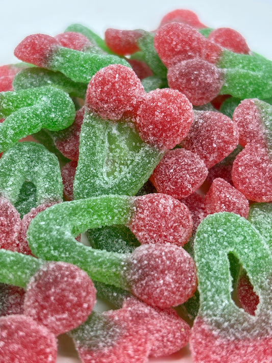 Select Sweets gummy cherry candy in red and green with sugar coating close-up