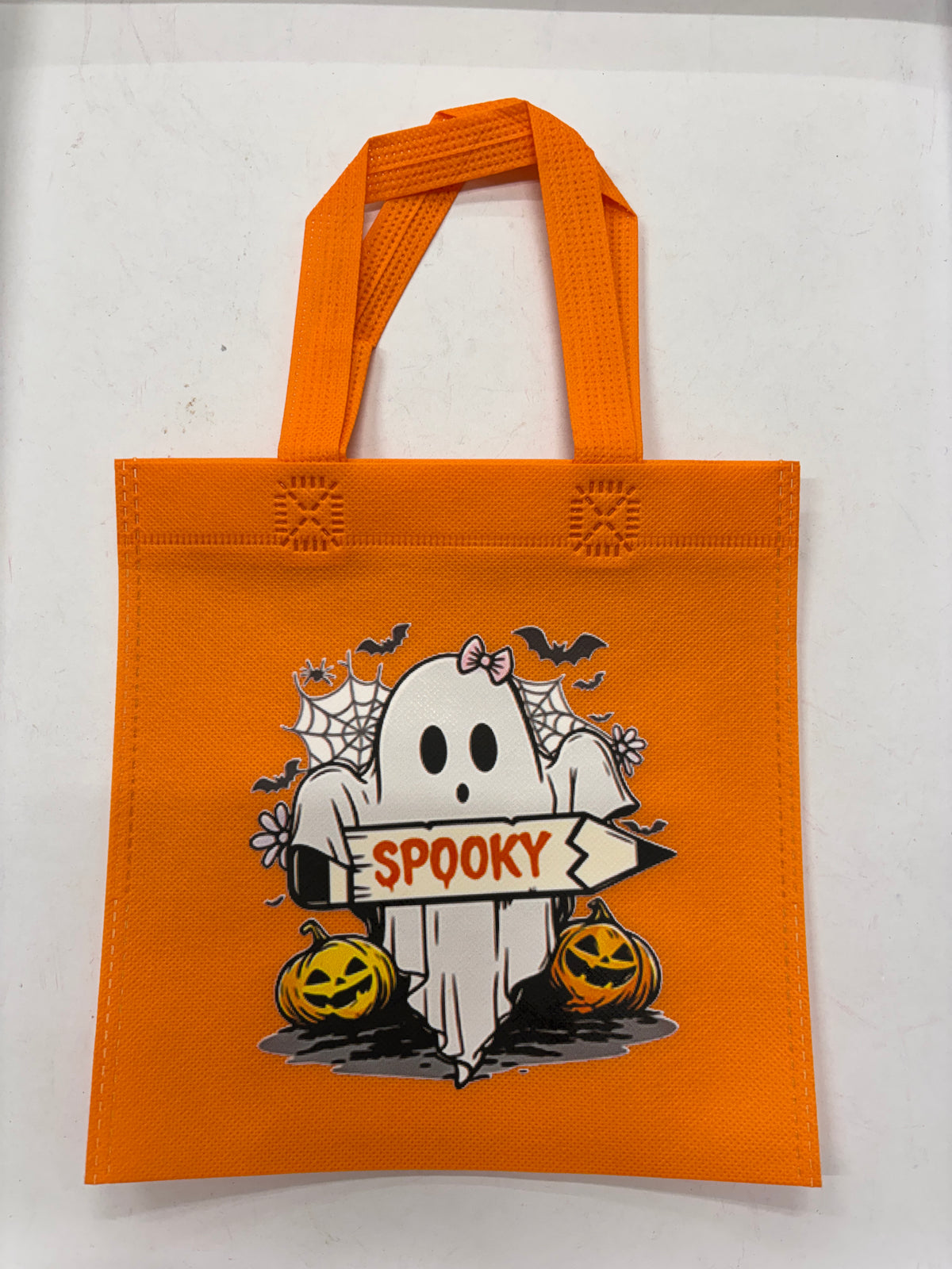 Orange Halloween tote bag featuring a ghost and pumpkins with spooky designs