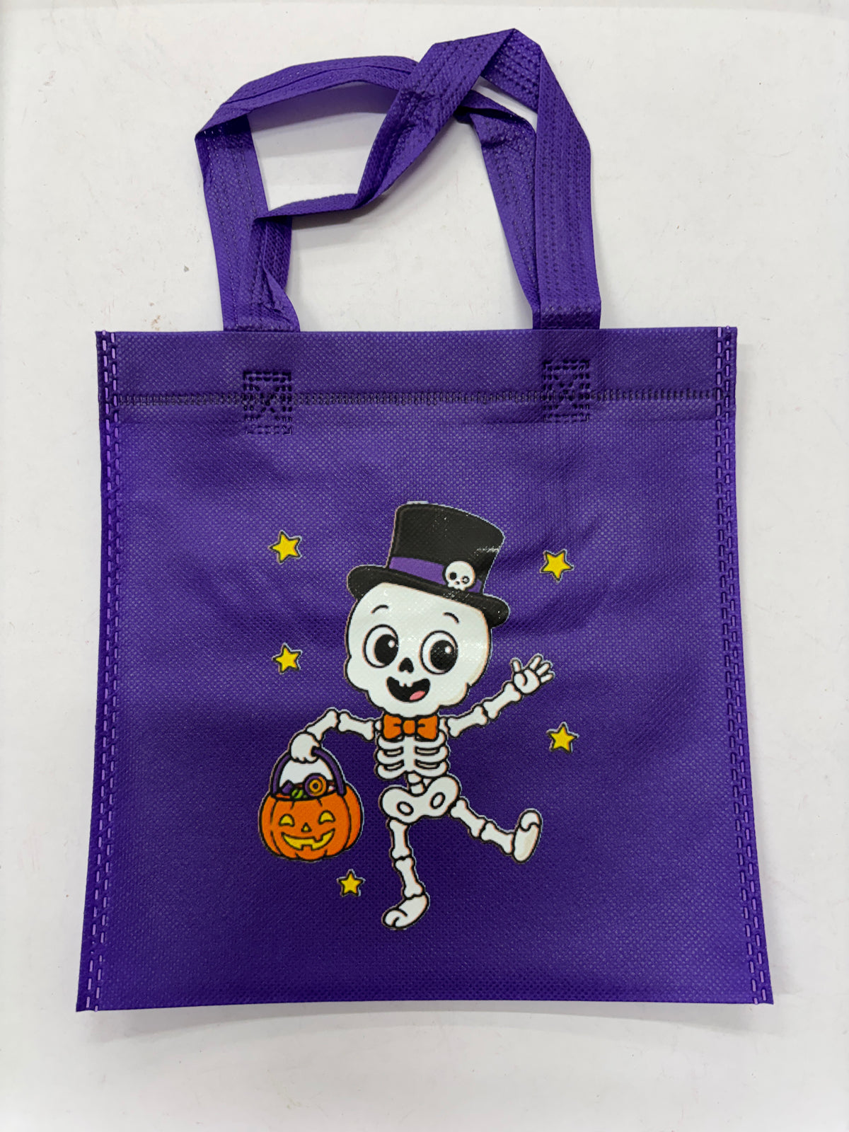 Purple Halloween Treat Bag featuring a dancing skeleton with a pumpkin bucket
