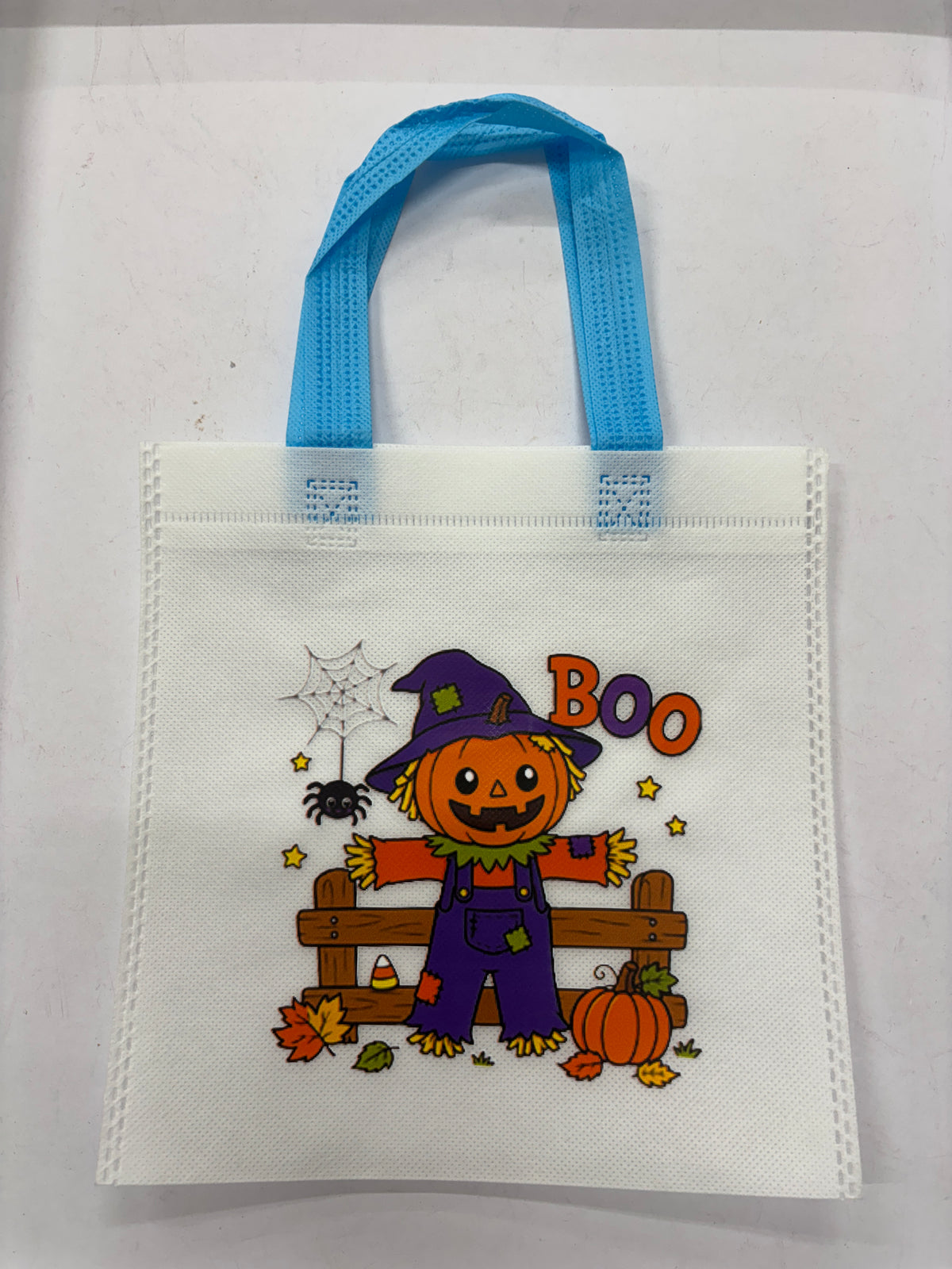 Halloween themed tote bag featuring a scarecrow character and colorful decorations