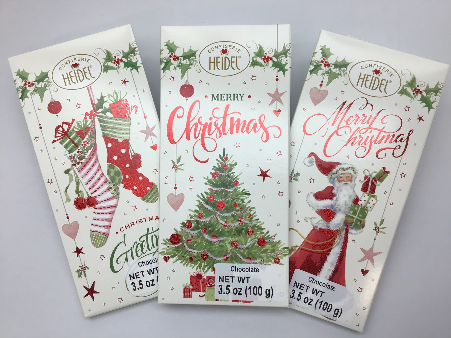 Heidel Christmas chocolate bar trio featuring festive designs of stockings, Christmas trees, and Santa