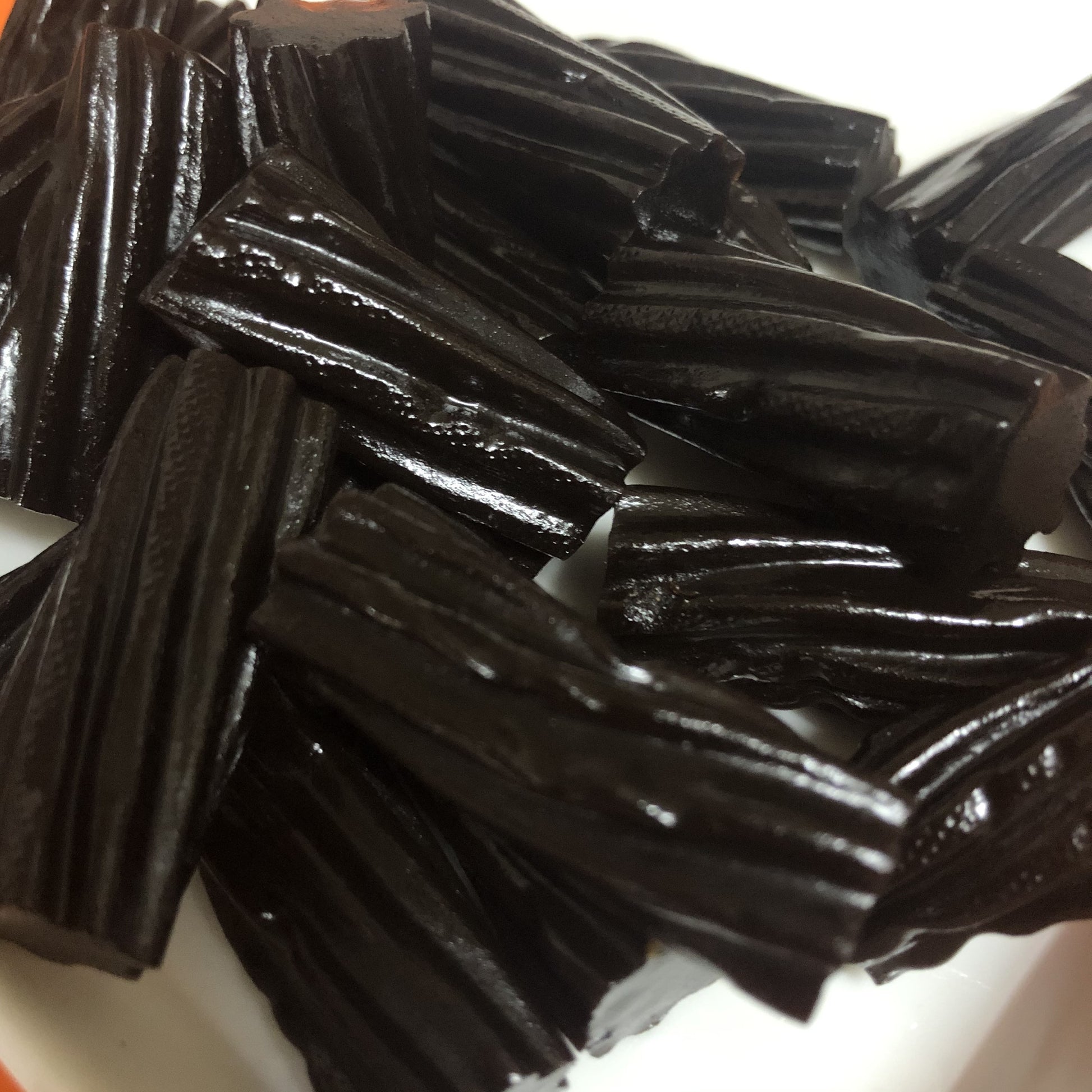 Select Sweets Licorice Twists in a bowl, showcasing their rich black color and chewy texture