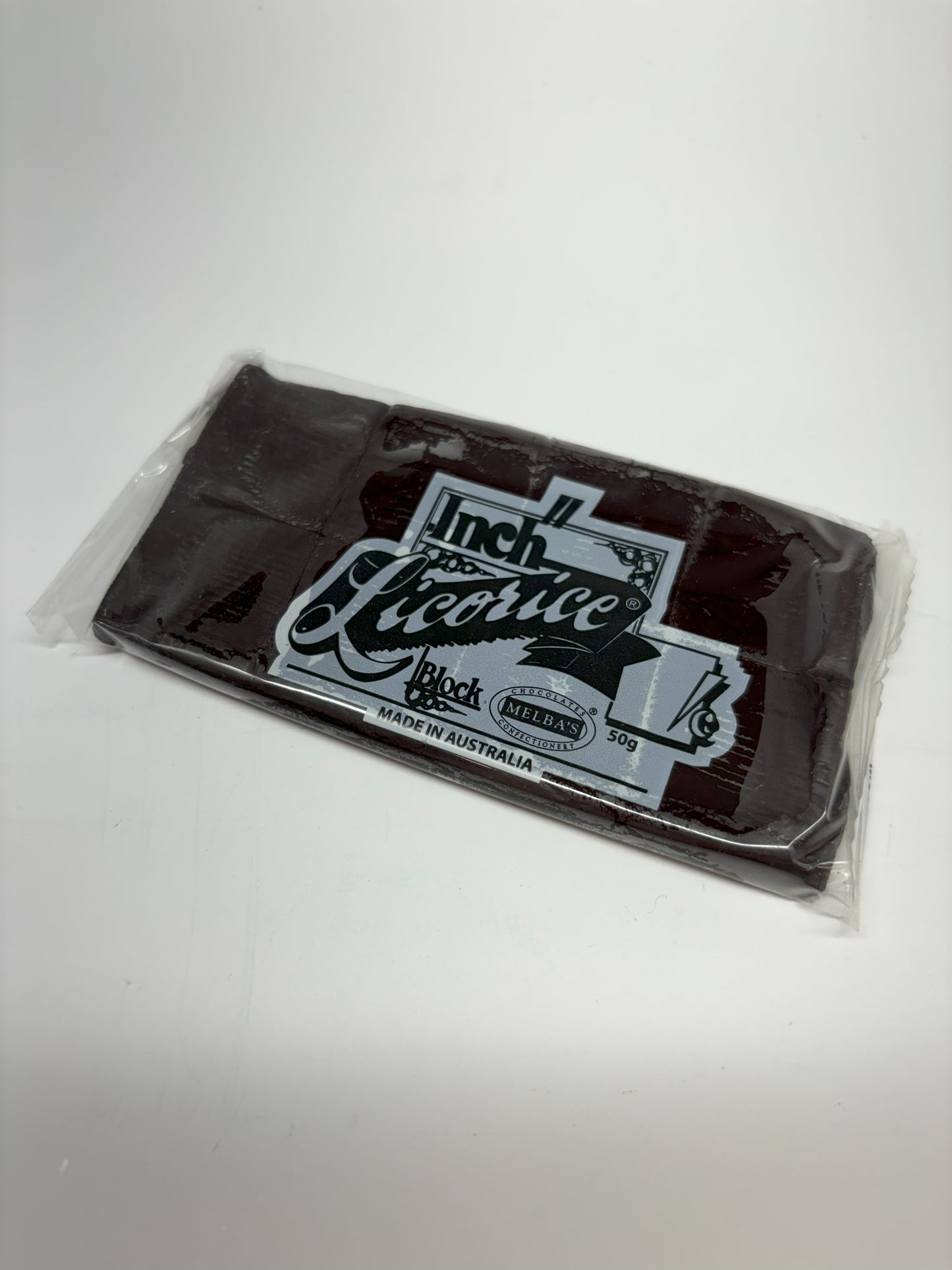 Select Sweets Inch licorice block candy packaged with clear wrapper and black label