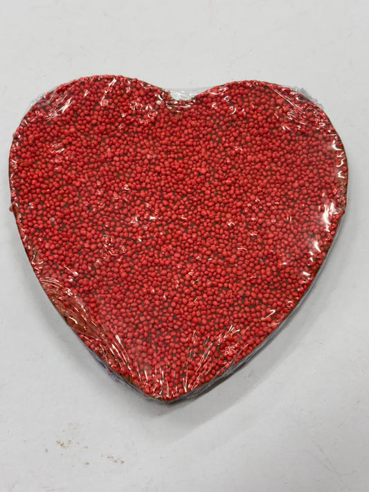 Milk chocolate heart with red sprinkles, a sweet treat perfect for gifting or celebration