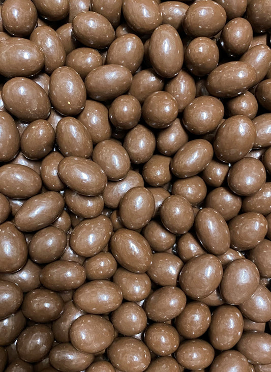 Close-up of SelectSweets milk chocolate scorched almonds with smooth glossy coating