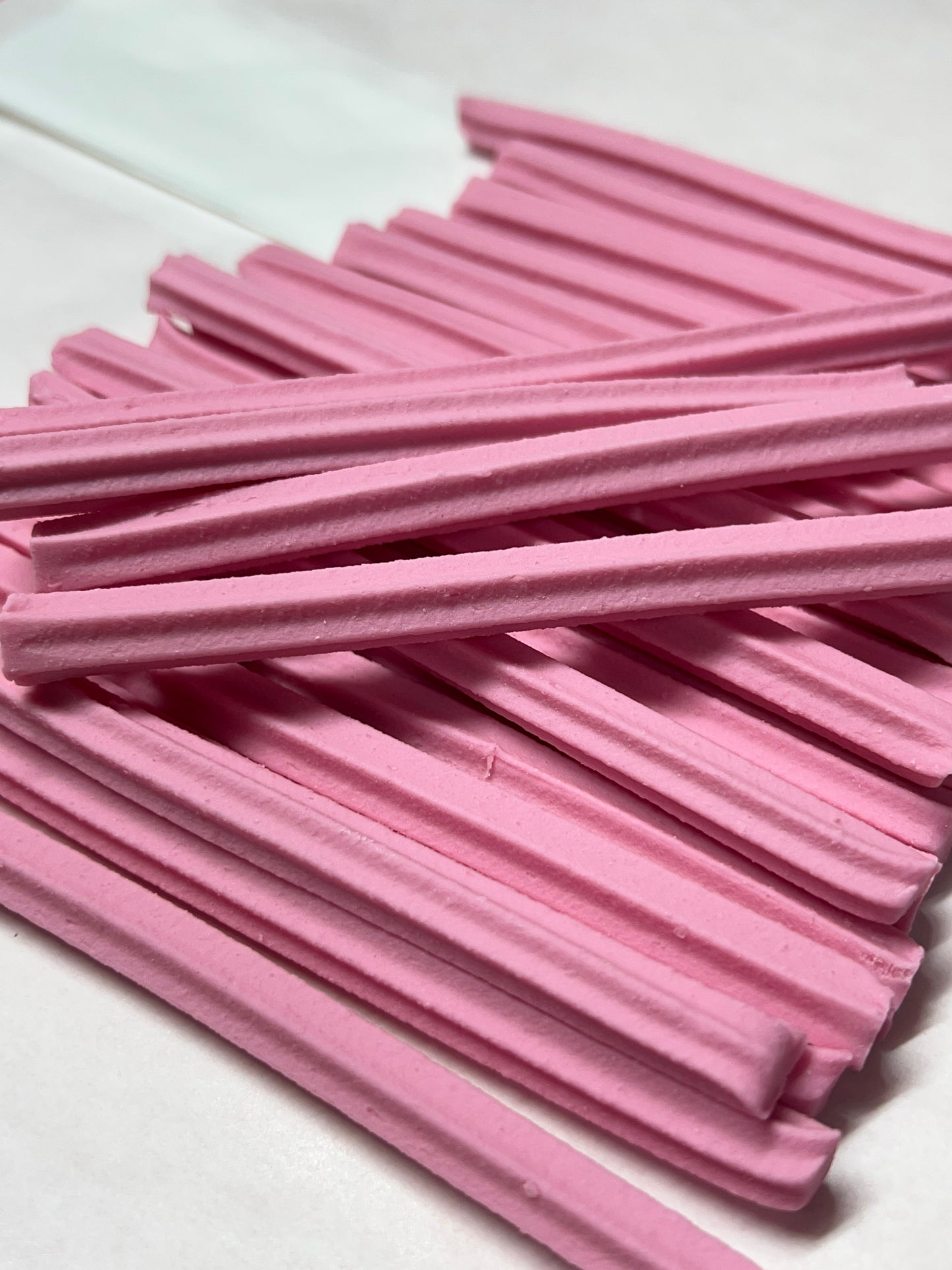 Musk sticks candy in a pile with a soft pink texture, perfect for sweet snacking