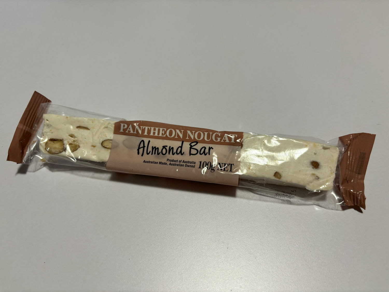Select Sweets almond nougat bar wrapped in clear packaging with visible almonds inside