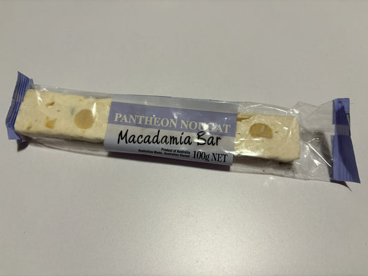 Select Sweets macadamia nougat bar in clear packaging showing white nougat with macadamia nuts