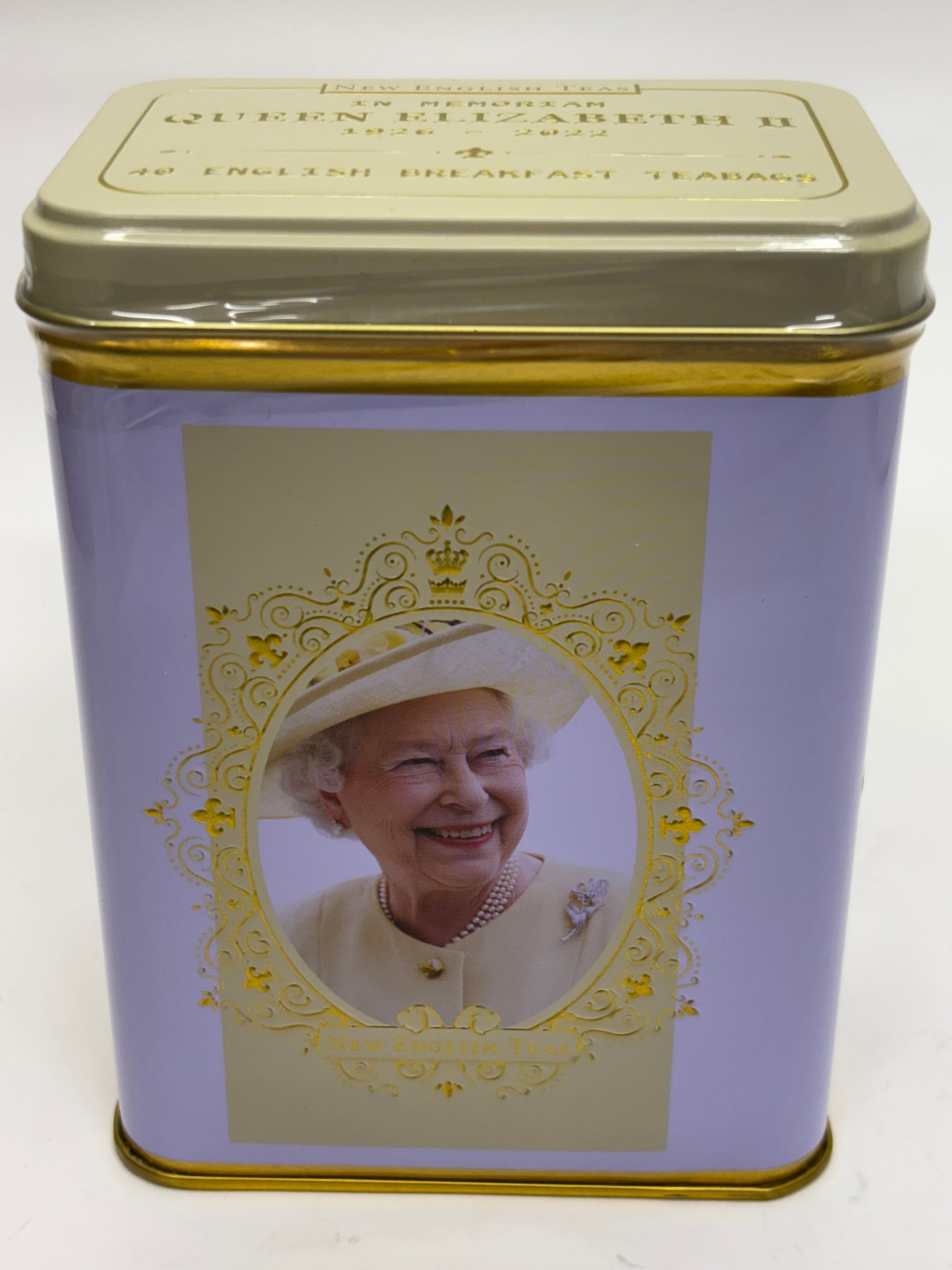 Select Sweets Queen Elizabeth tea tin with a gold lid and portrait of Queen Elizabeth on a lavender background