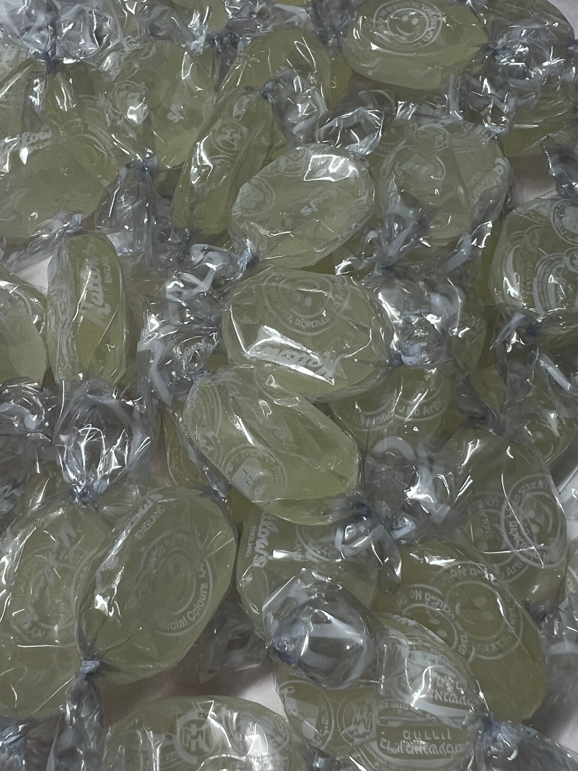 SelectSweets1 sour lemon candy individually wrapped in clear plastic with a yellow tint