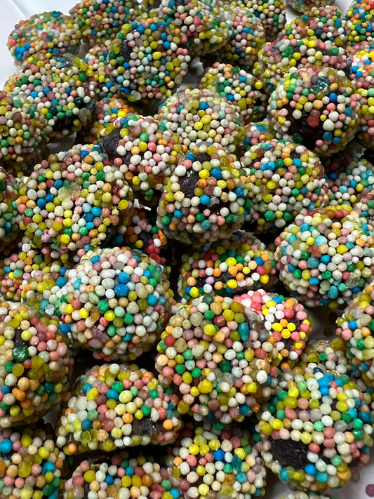 SelectSweets spiced berry candy covered in colorful candy sprinkles close-up view
