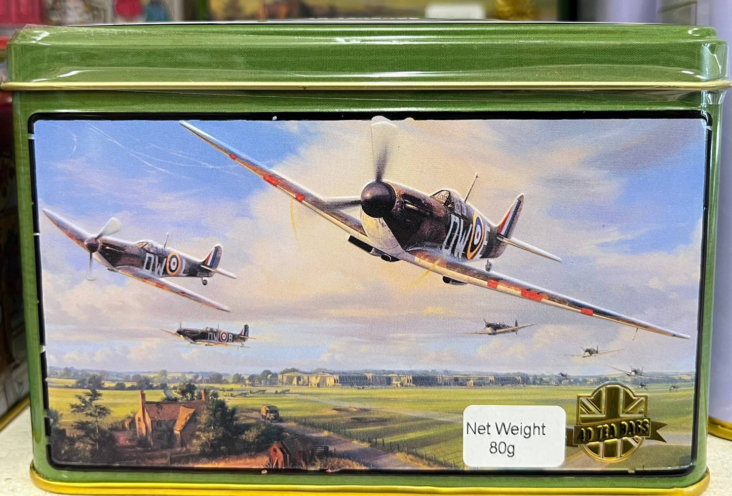 Select Sweets Spitfire tea tin featuring a vintage aircraft design with a scenic background
