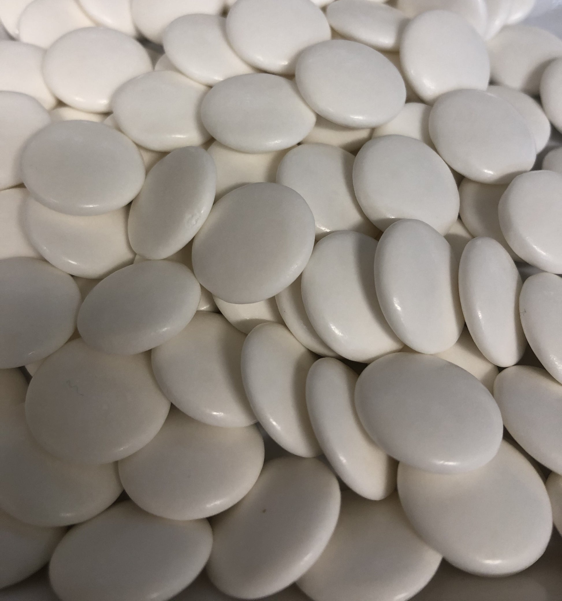 Close-up of SelectSweets1 strong peppermint candies in smooth white round shapes
