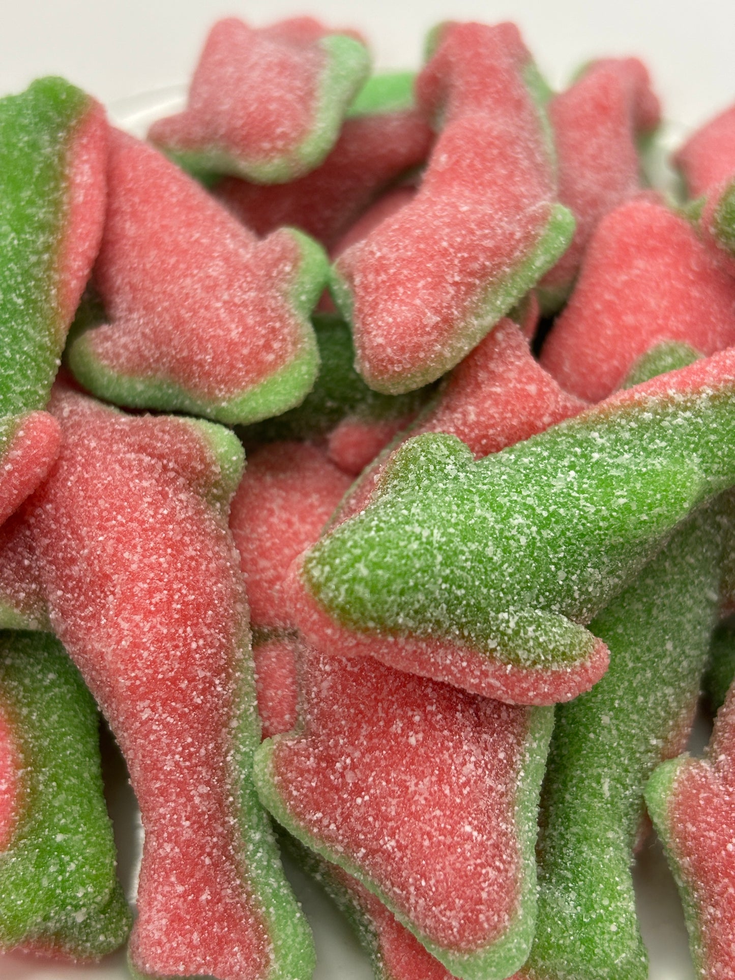 Close-up of Select Sweets Trolli Watermelon Sharks candy with red and green sugar-coated gummy sharks
