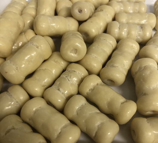 Close-up of SelectSweets white chocolate raspberry bullets with creamy white coating and textured surface