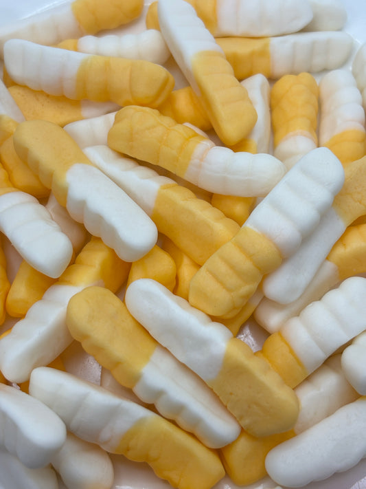 Close-up of Select Sweets witchetty grub candy in yellow and white gummy shapes